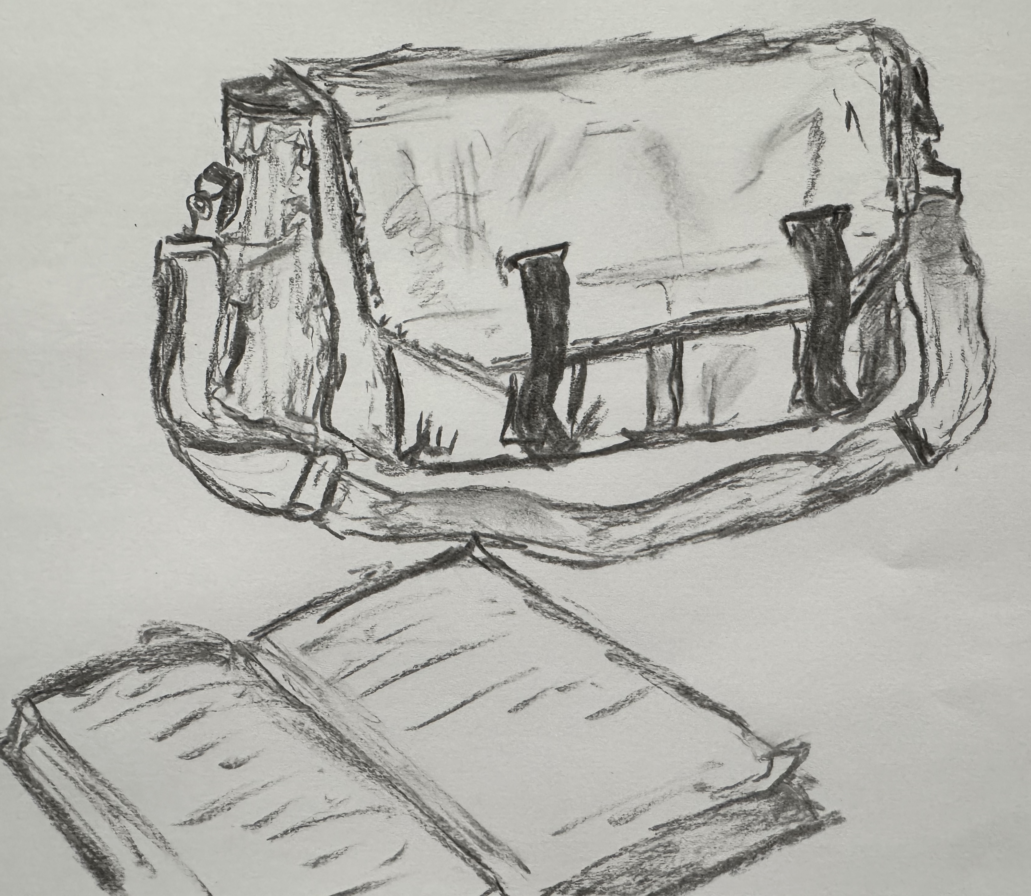 Charcoal sketch of a graduation cap and open book